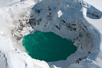 An overflight of snow-capped volcanoes